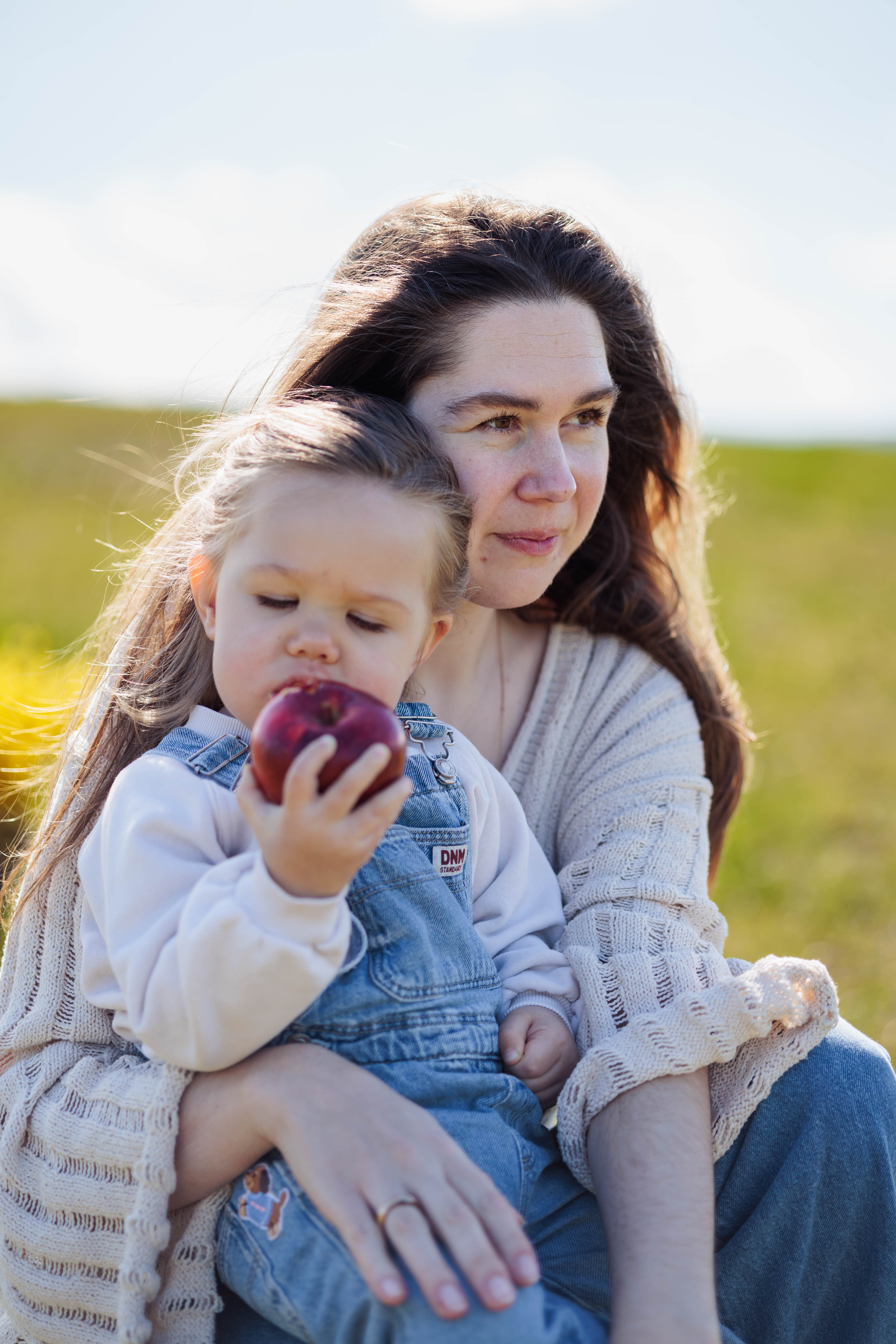 A couple embraces lovingly on a wooden dock.