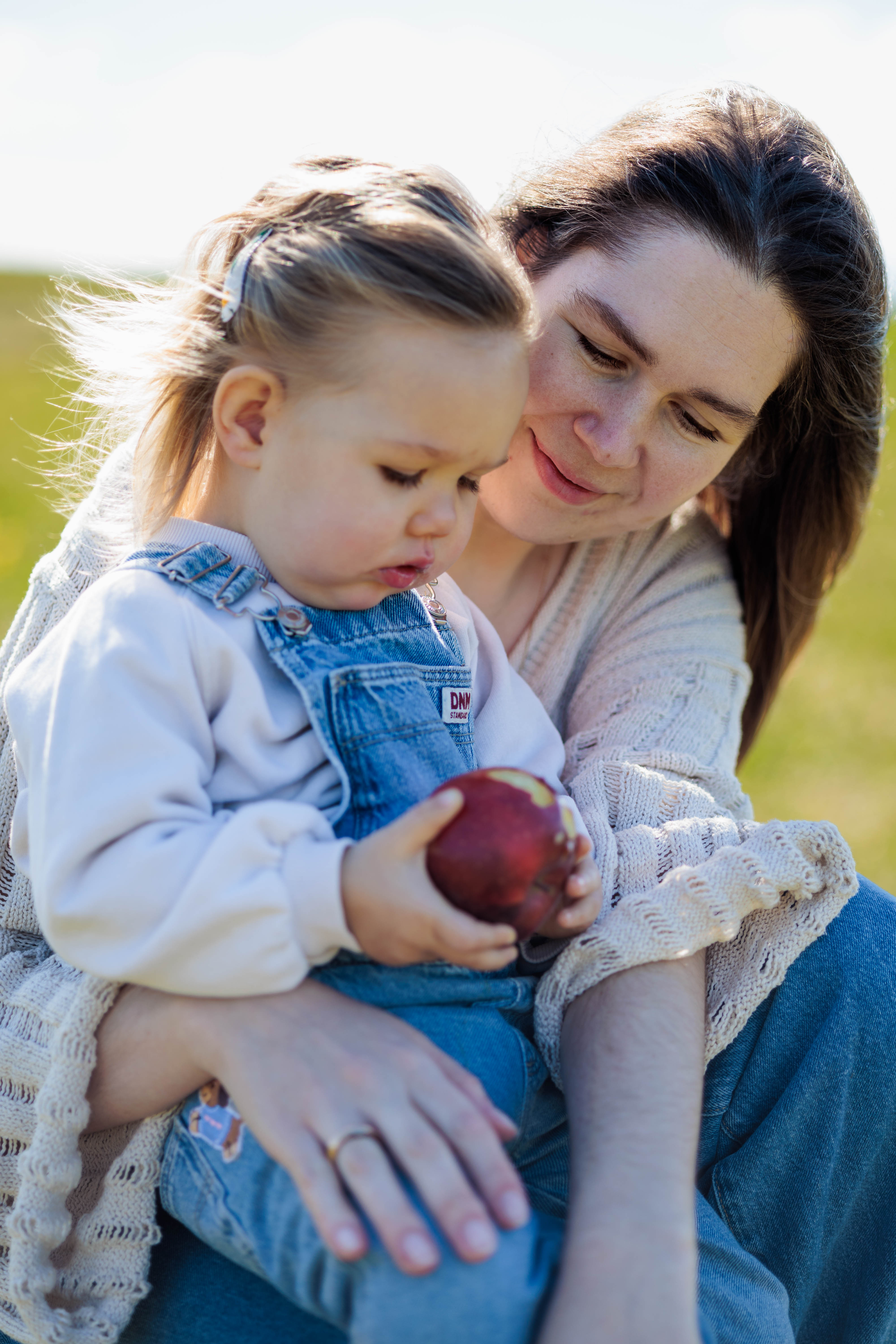 Family of mother, kid and father with flowers and apples