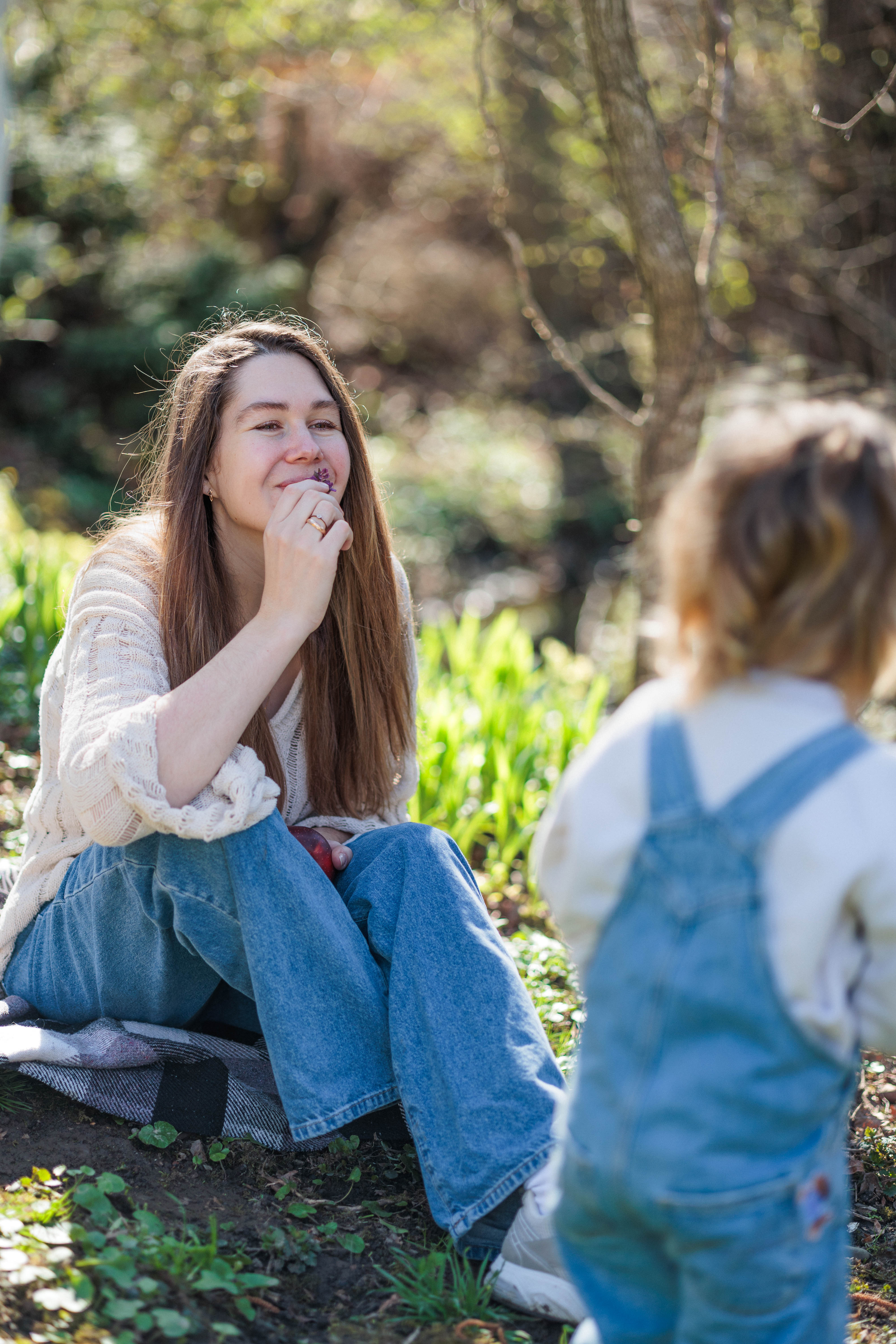 A couple stands outdoors at sunset.