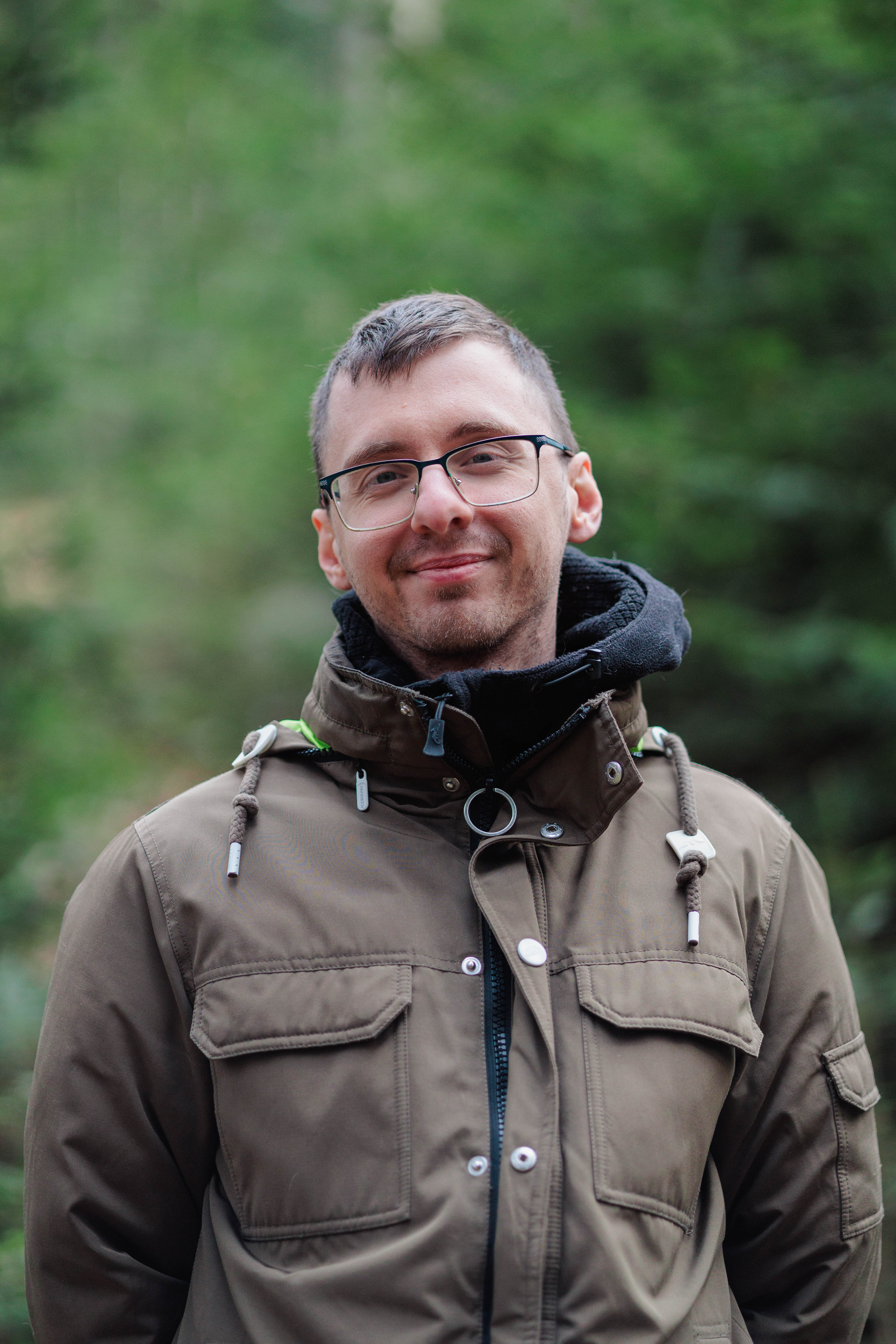 A vibrant bridal bouquet featuring a mix of red, pink, and purple flowers.